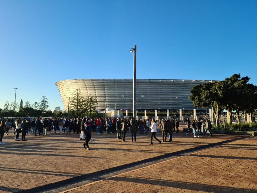 a crowd of people walking around a stadium