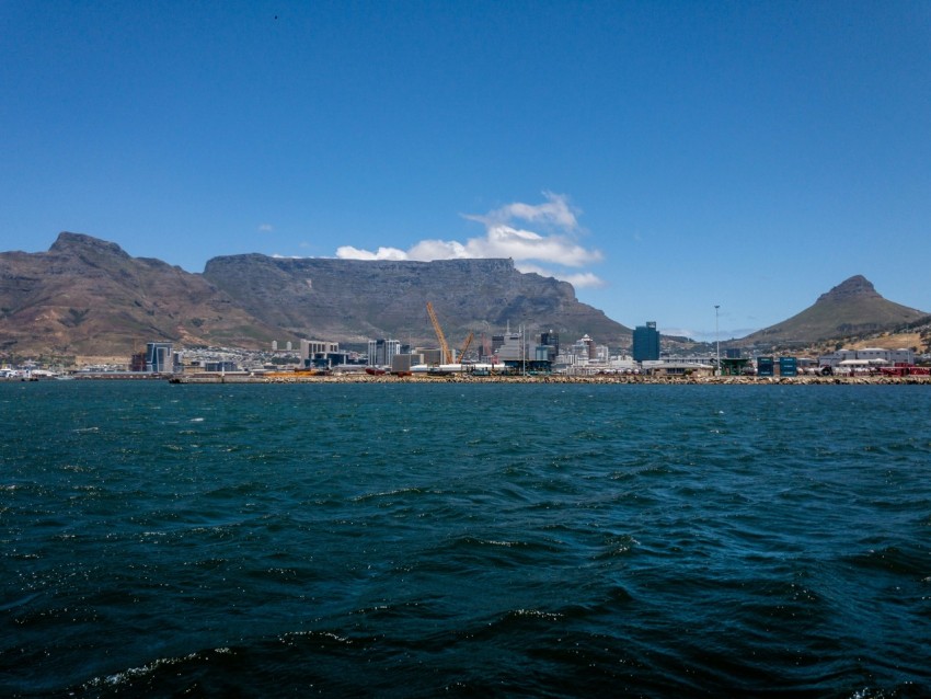 a large body of water with mountains in the background