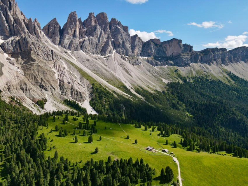 an aerial view of a mountain range with a road running through it