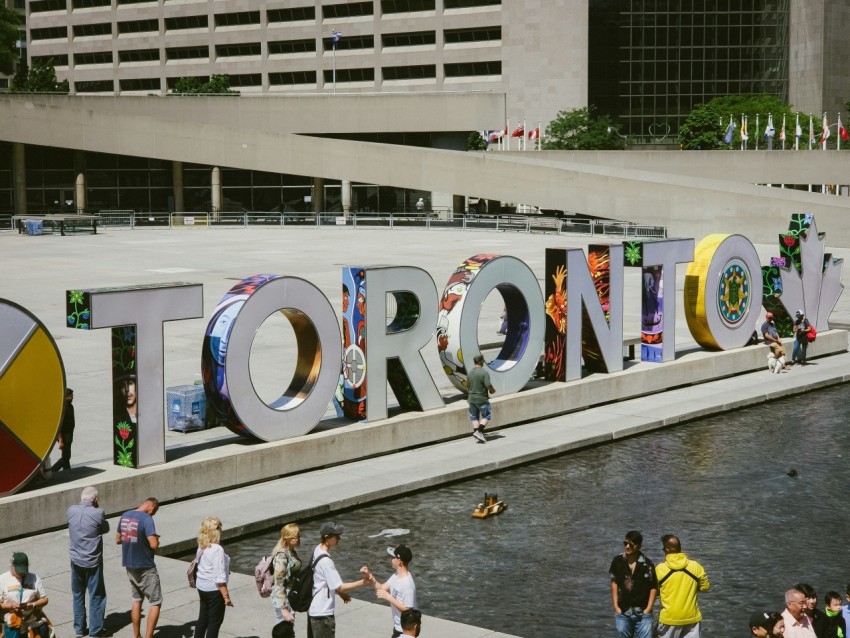 a group of people standing in front of a sign