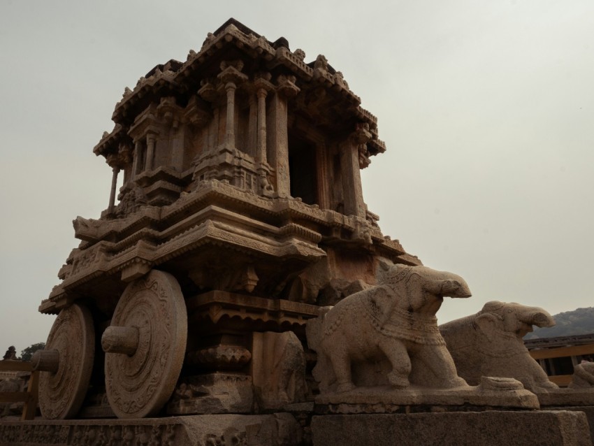 a statue of a chariot with animals on it