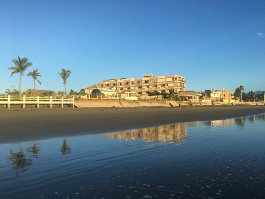 a view of a beach with a building in the background