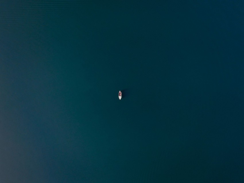 a small boat floating on a large body of water