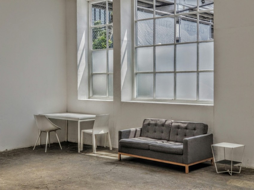 gray and black couch beside white window