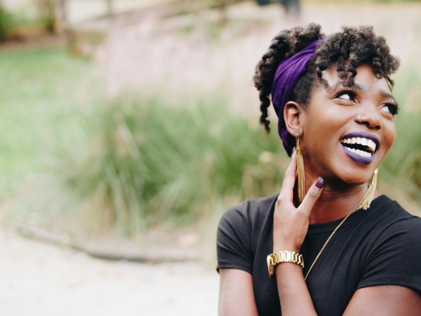 photo of woman wearing purple lipstick and black crew neck shirt