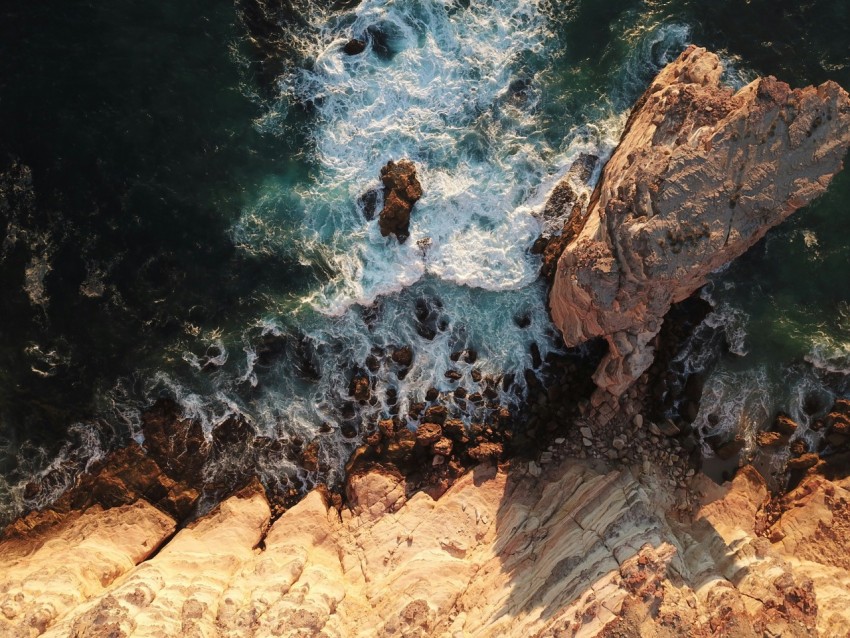 brown rocks on body of water in high angle view photo