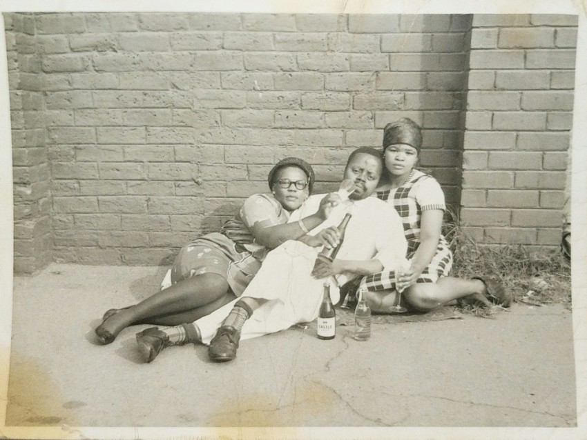 2 men and 2 women lying on ground in grayscale photography