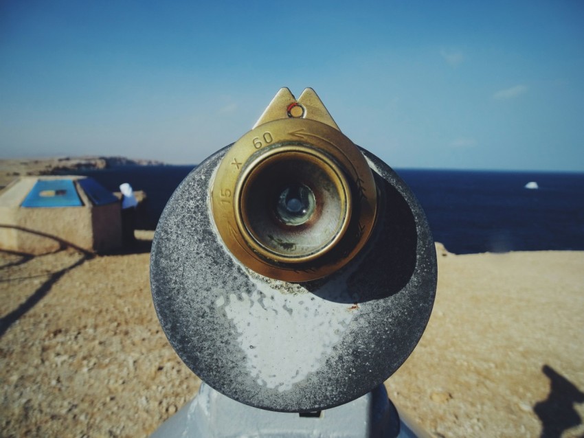 a close up of a metal object near the ocean