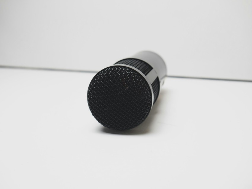 a black microphone on a white surface