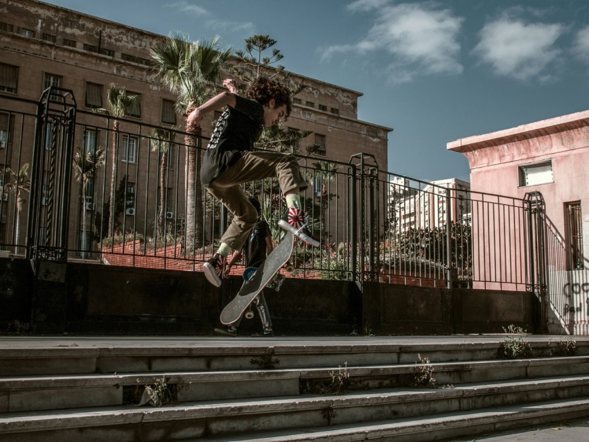 a man flying through the air while riding a skateboard X