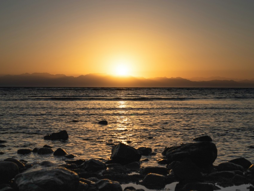 silhouette of rocks on sea during sunset yan6j 1A8