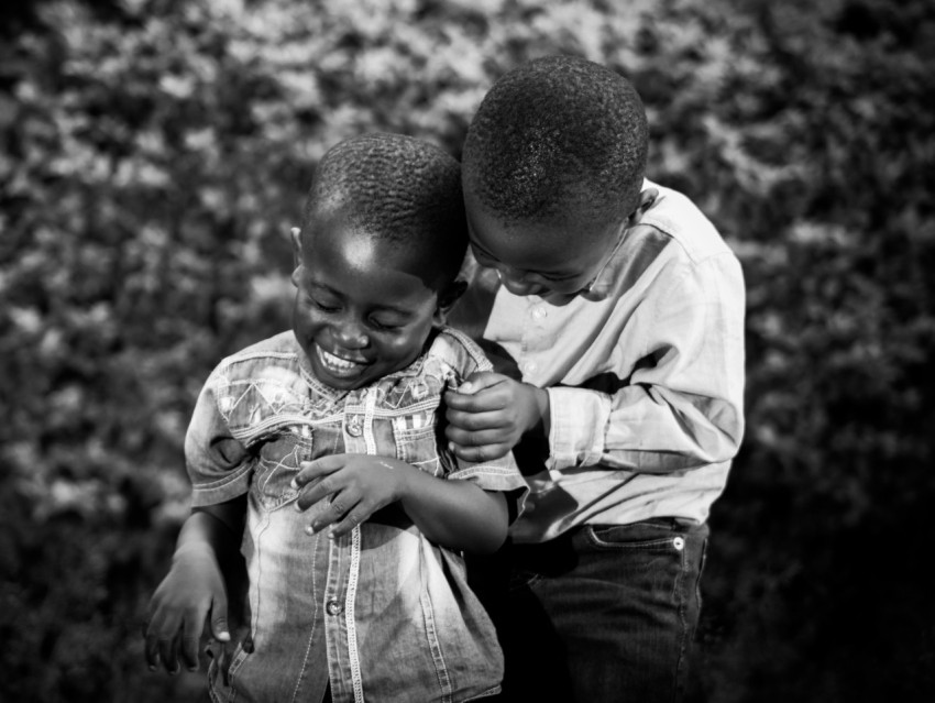 a couple of young boys standing next to each other FtULc