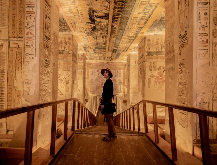 a woman standing on a bridge in an egyptian temple