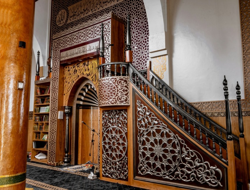 a staircase in a building with a wooden banister