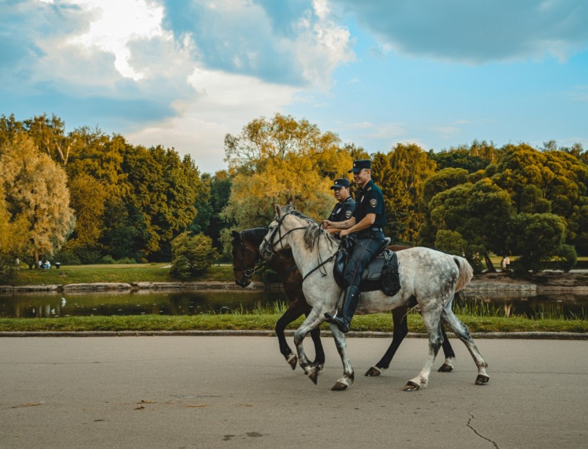 a couple of people riding on the backs of horses