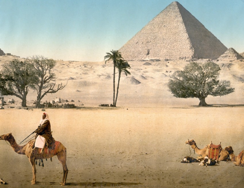 resting bedouins and the grand pyramid cairo egypt