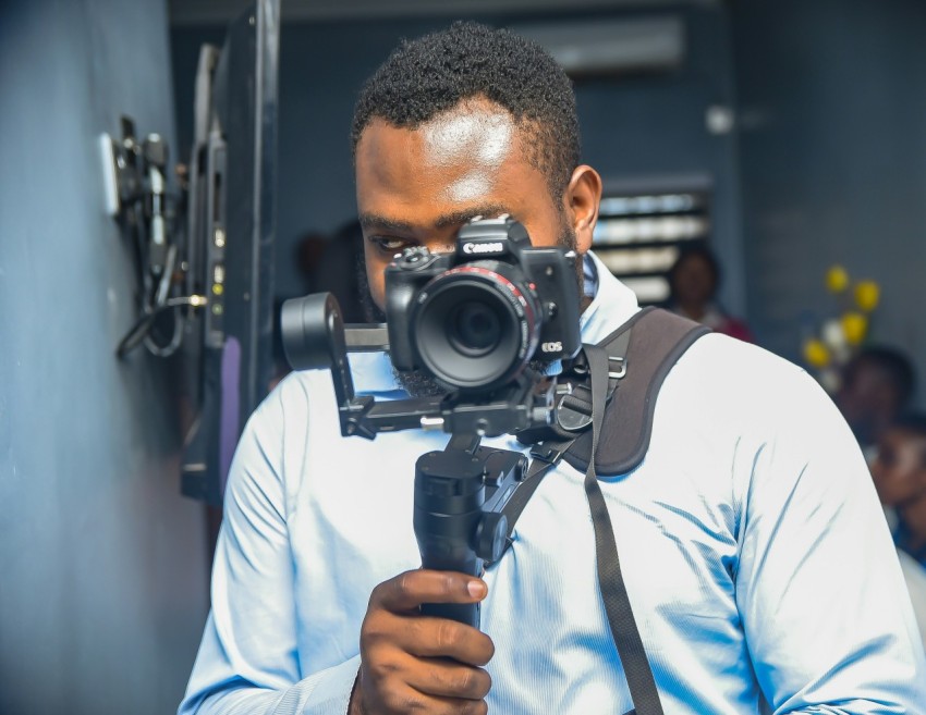 a man holding a video camera up to his face