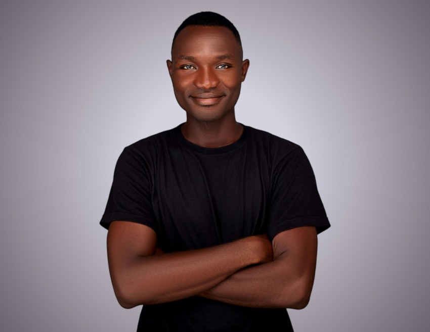 a black man with his arms crossed looking at the camera