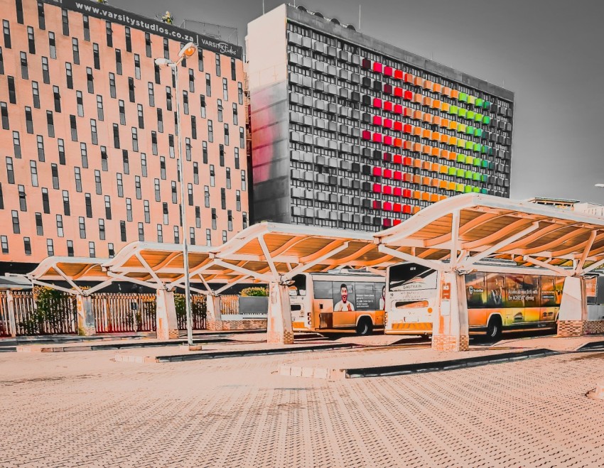 a bus stop in front of a large building