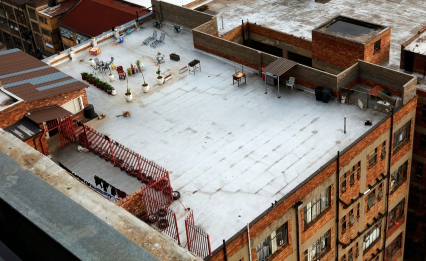an aerial view of a building with a roof covered in snow nmIpX
