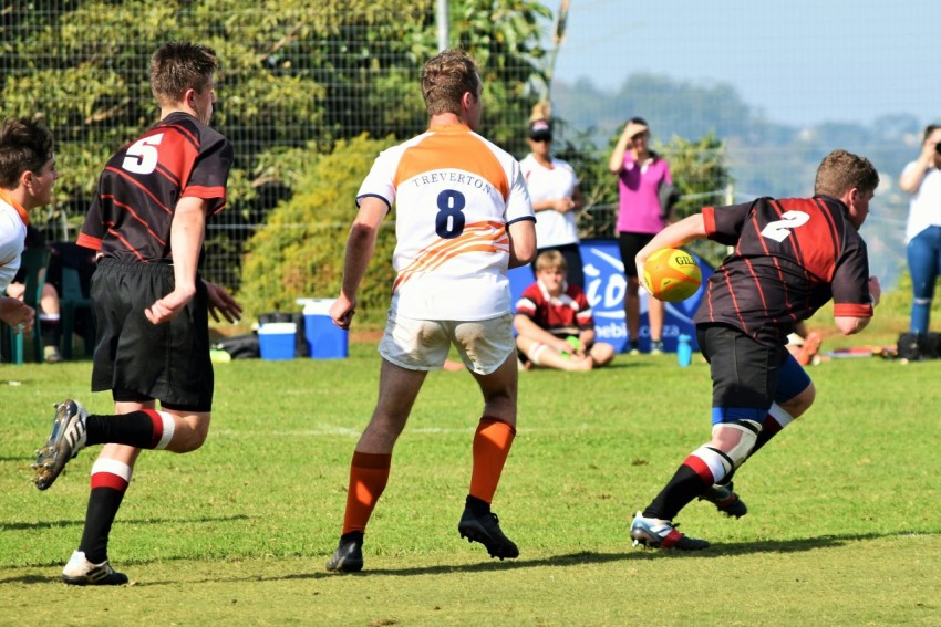 woman in white and black jersey shirt playing soccer during daytime