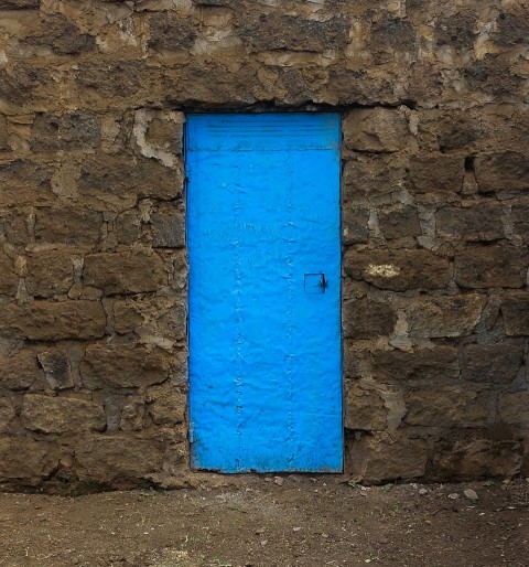 a blue door on a stone building