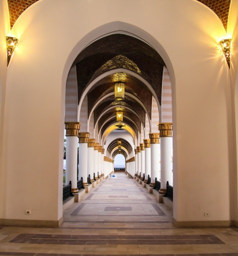 white concrete building with black metal gate zt