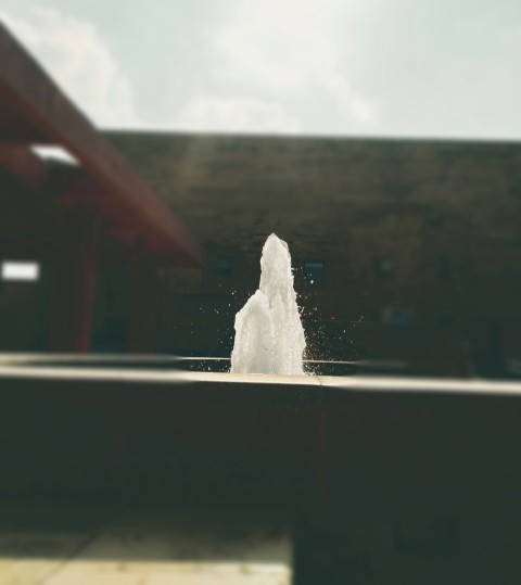 a fountain spewing water into a pool of water