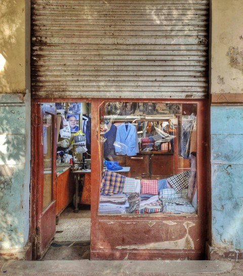 an open door to a store with clothes on display