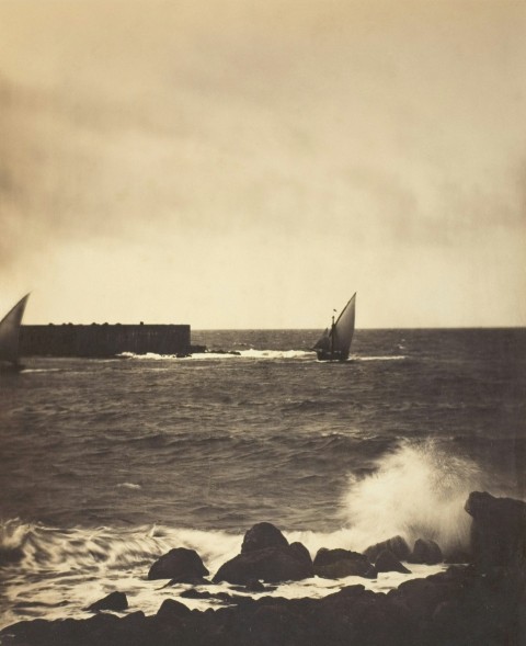 a black and white photo of a boat in the ocean