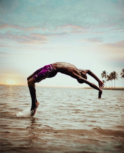 a man is doing a handstand in the water