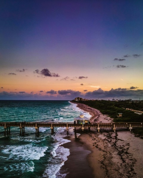 brown wooden dock on sea during sunset