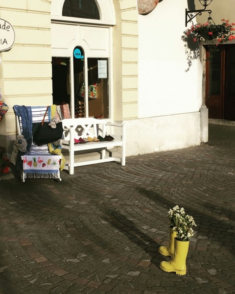 a white bench sitting in front of a building