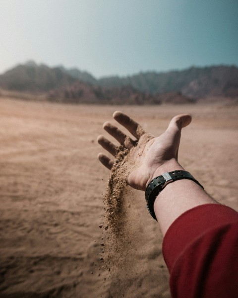 person wearing silver link bracelet watch