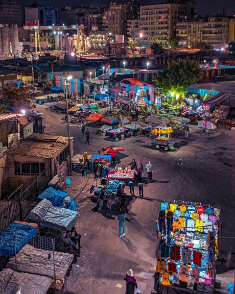 a group of people walking around a crowded street