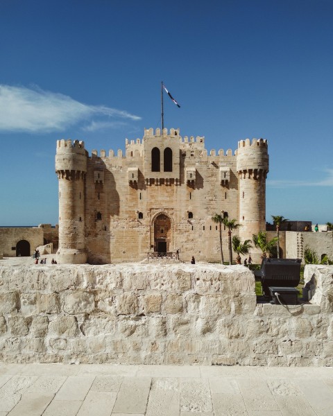 a stone castle with a flag on top of it