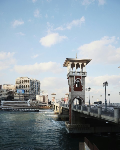 a bridge over water with buildings on the side