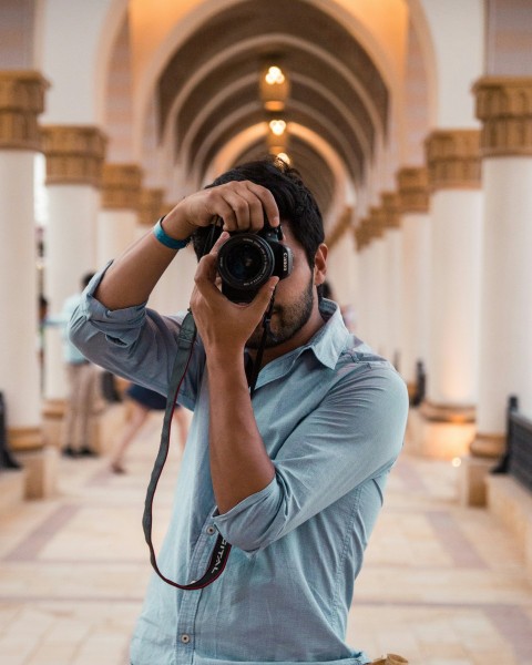 man holding dslr camera