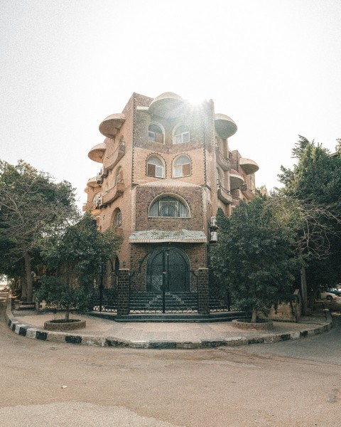 a large brick building with a gate in front of it