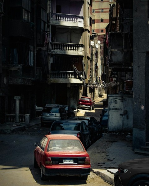 a red car parked on the side of a street