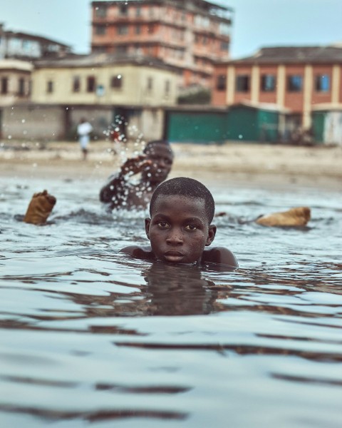 Boys in water during daytime