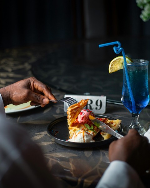 a plate of food and a drink on a table 2pO