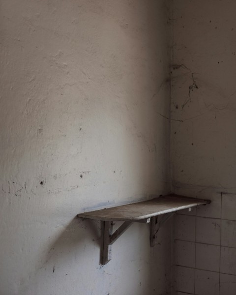 white and black table beside white wall