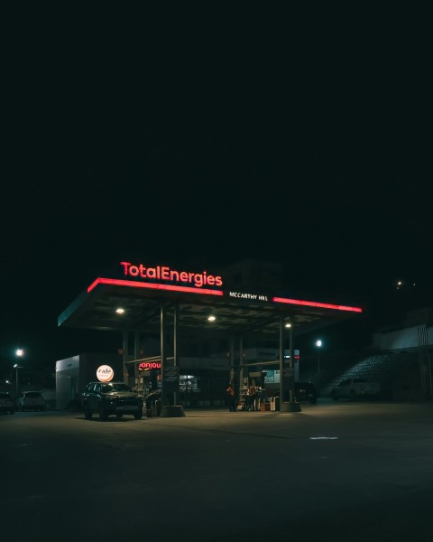 a gas station at night with the lights on