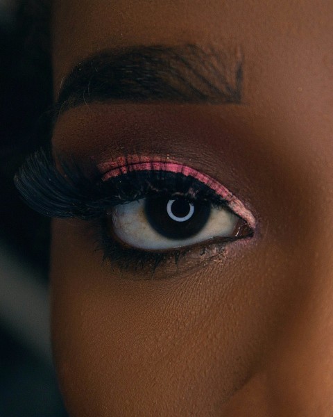 a close up of a womans eye with long lashes