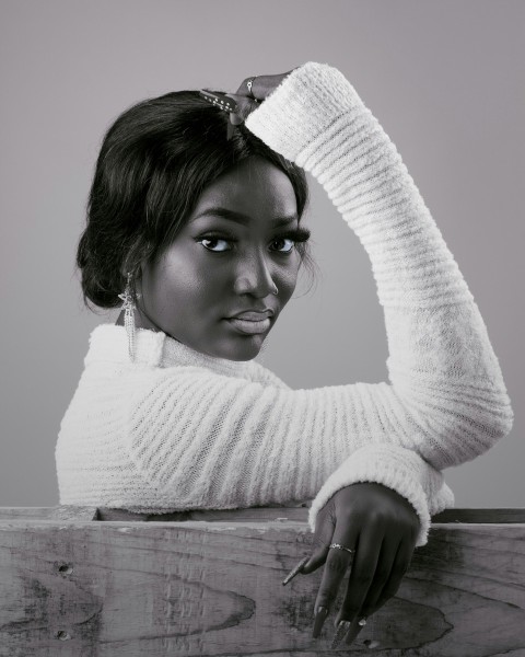 a black and white photo of a woman in a sweater