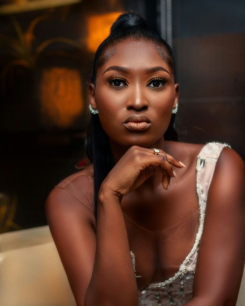 a woman in a white dress posing for a picture