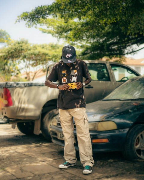 a man standing in front of a parked car