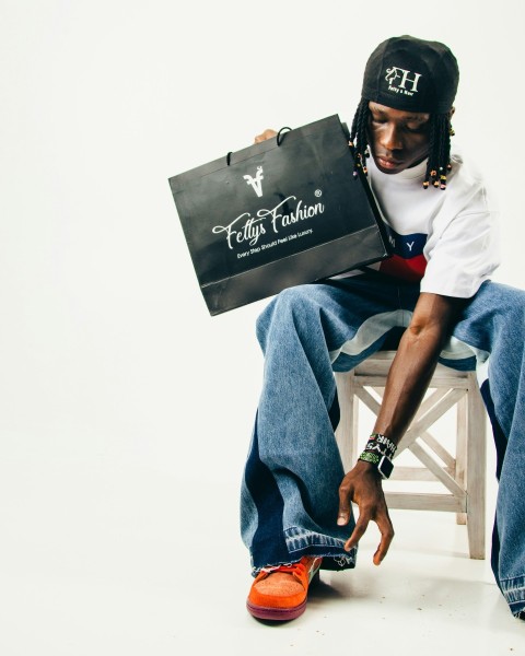 a man sitting on a chair holding a bag