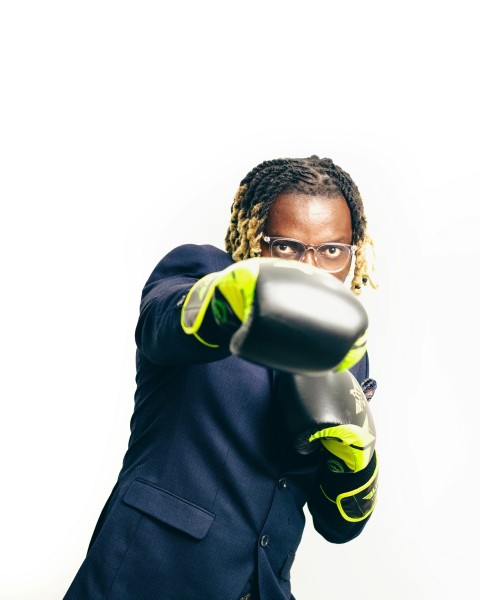 a woman in a suit holding a blow dryer